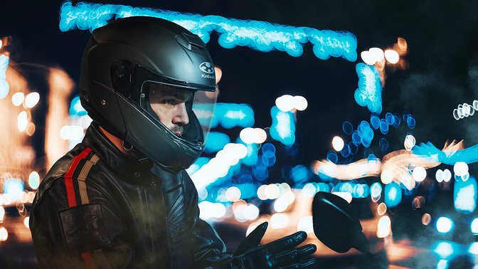 Honda Kabuto helmet, Aeroblade V - Flat Black - Superimposed, 3-quarter front right side, on the head of a biker, in the city at night