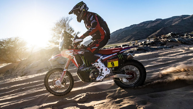 Left side Honda CRF450 riding through sand dunes.