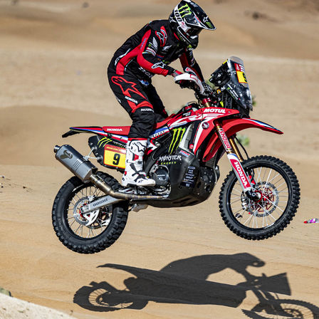 Honda Dakar rider on motorcycle in the desert.