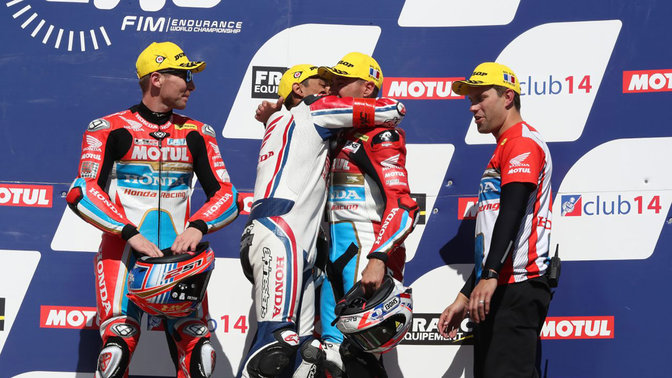 Honda EWC riders celebrating a victory.