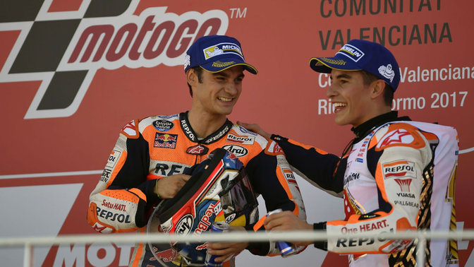 Two Honda MotoGP riders celebrating race victory.
