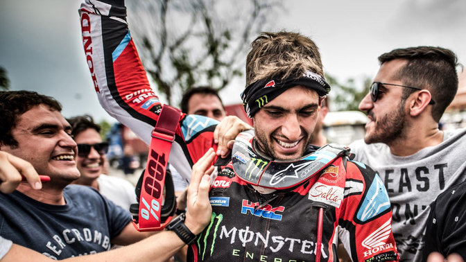 Honda Rally rider celebrating victory.