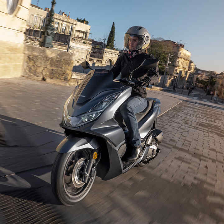 Honda PCX125 with city landscape behind