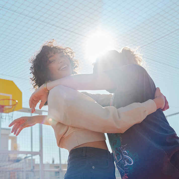 Two models hugging in sunlight on EM1 e: photoshoot
