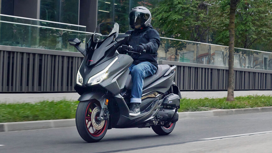 Honda Forza 125 action on road.