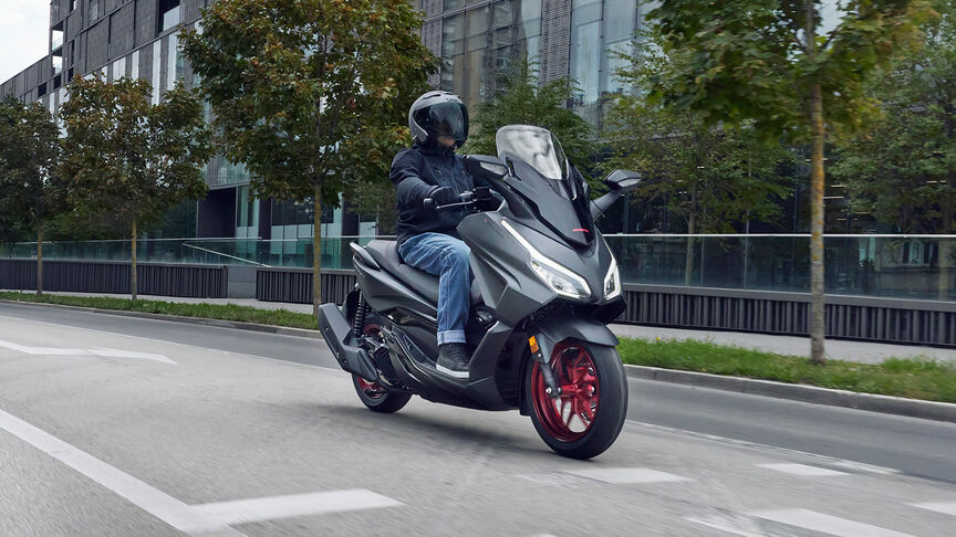 Honda Forza 125 action on road.