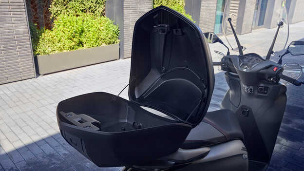 Close up of open Honda SH350i Smart top box. 