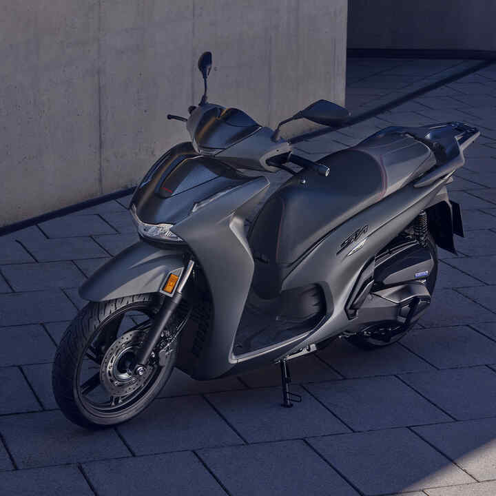 Static Front 3/4 Honda SH350i in courtyard location.
