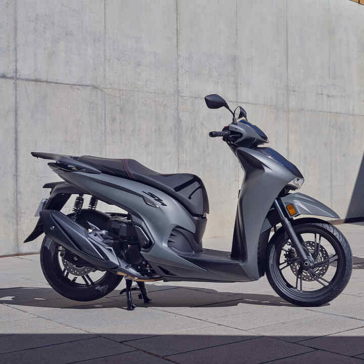 Two static Honda SH350i outside a building location. 