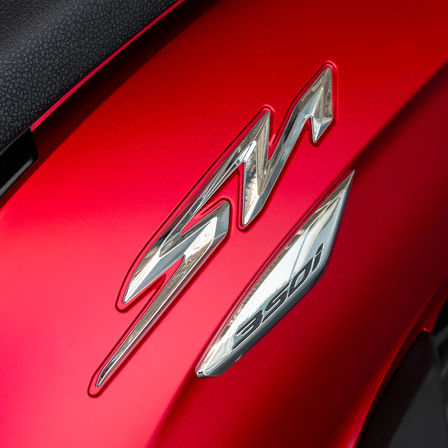 Honda SH350i, zoom on SH logo, red bike