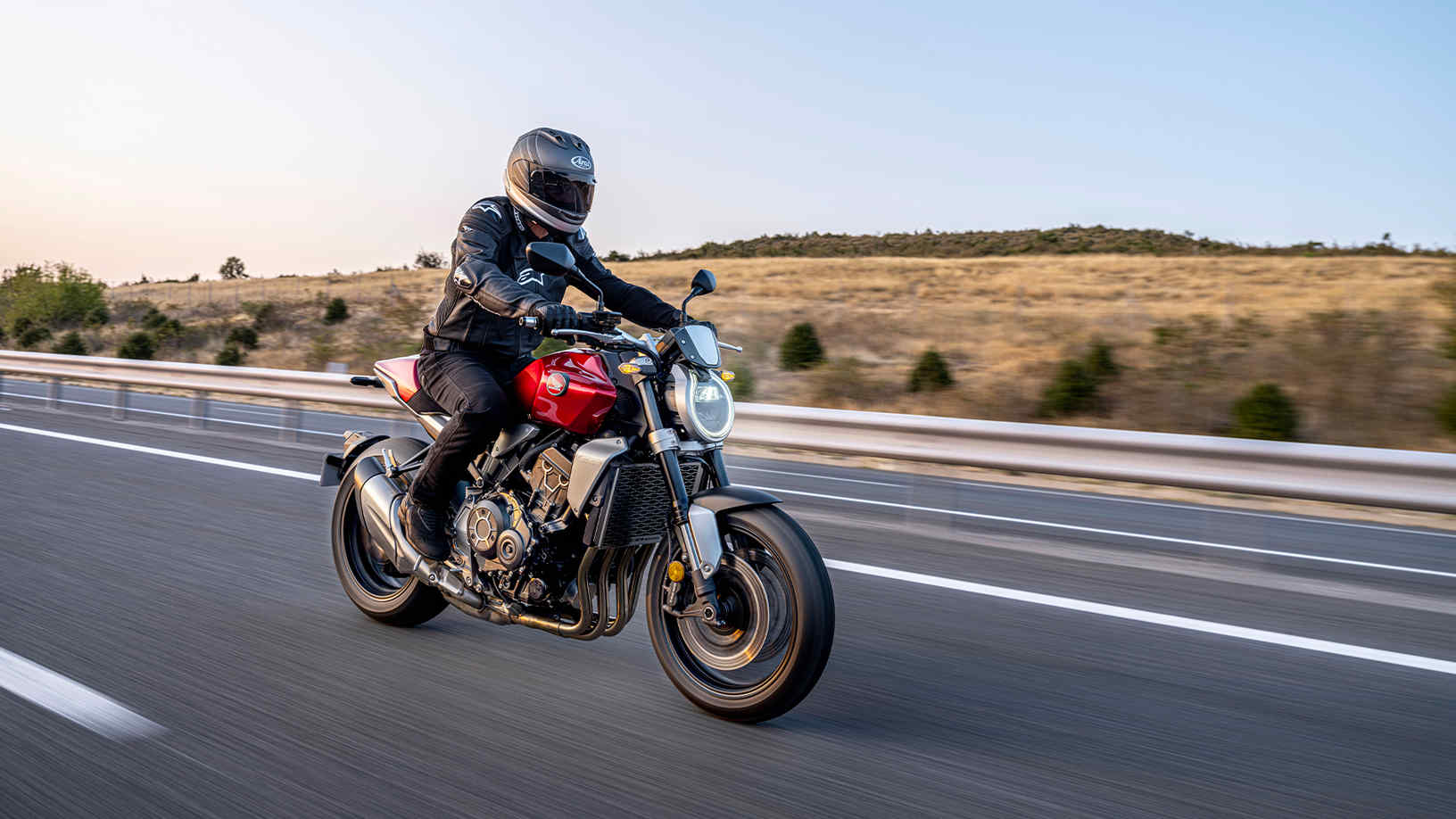 Honda CB1000R, 3-quarter right side, with a rider, red bike, on the road