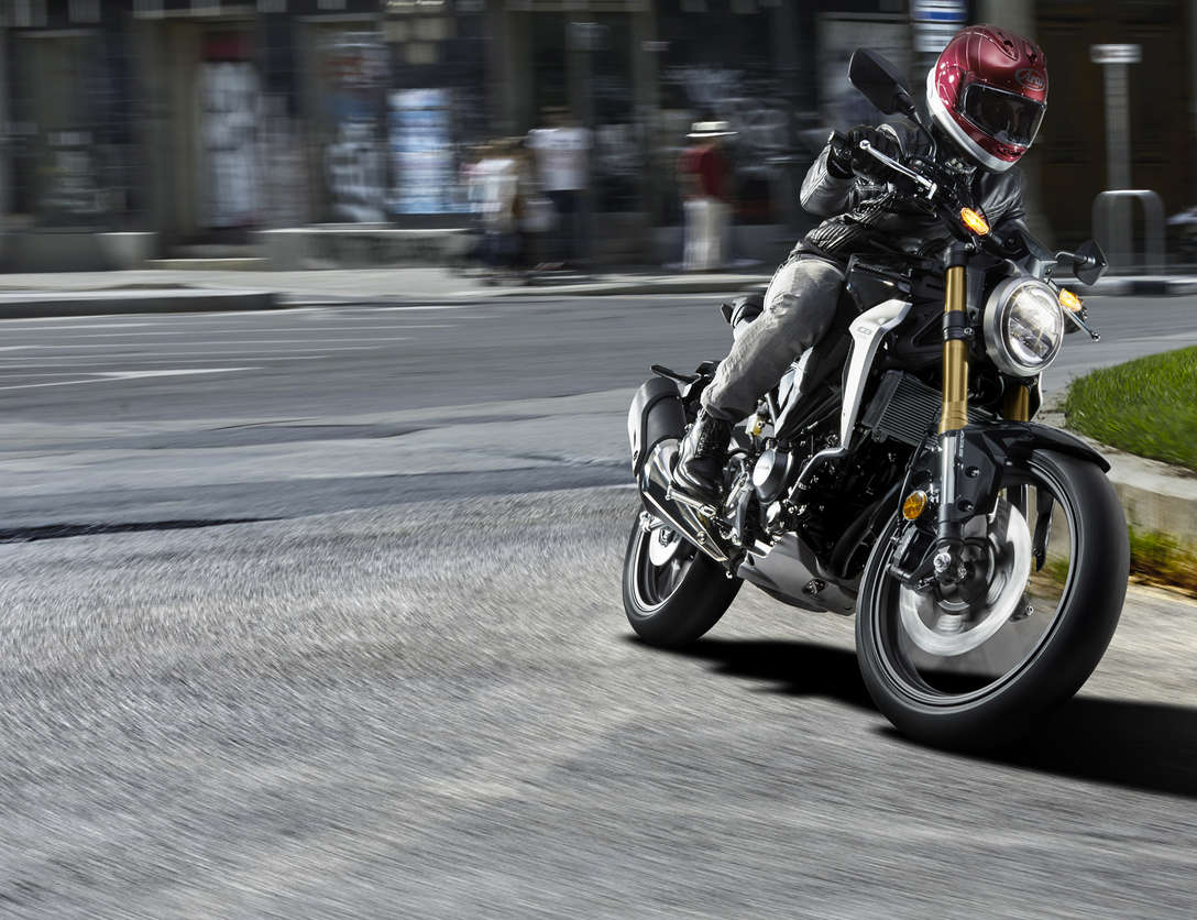 Front three-quarter facing Honda CB300R Neo Sports Café, being ridden on the street.