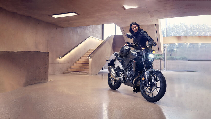 Honda CB300R Front facing three quarters being looked at by a women in a studio.