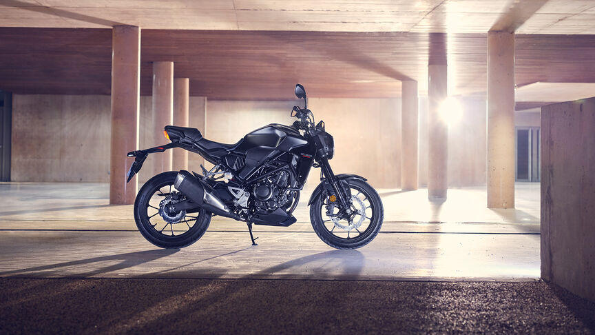 Honda CB300R Front facing three quarters being looked at by a women in a studio.