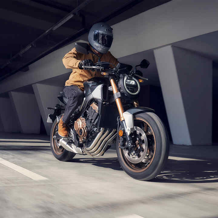 Rider on side facing Honda CB650R.