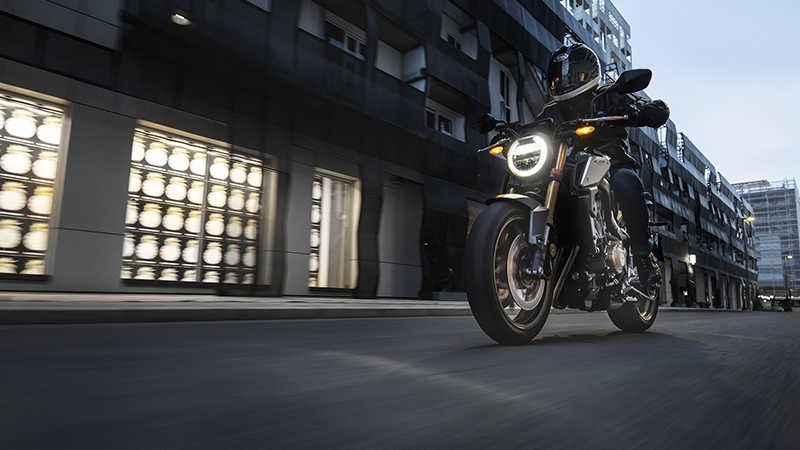 CB650R Neo Sports Café, 3-quarter left side with rider, in urban landscape