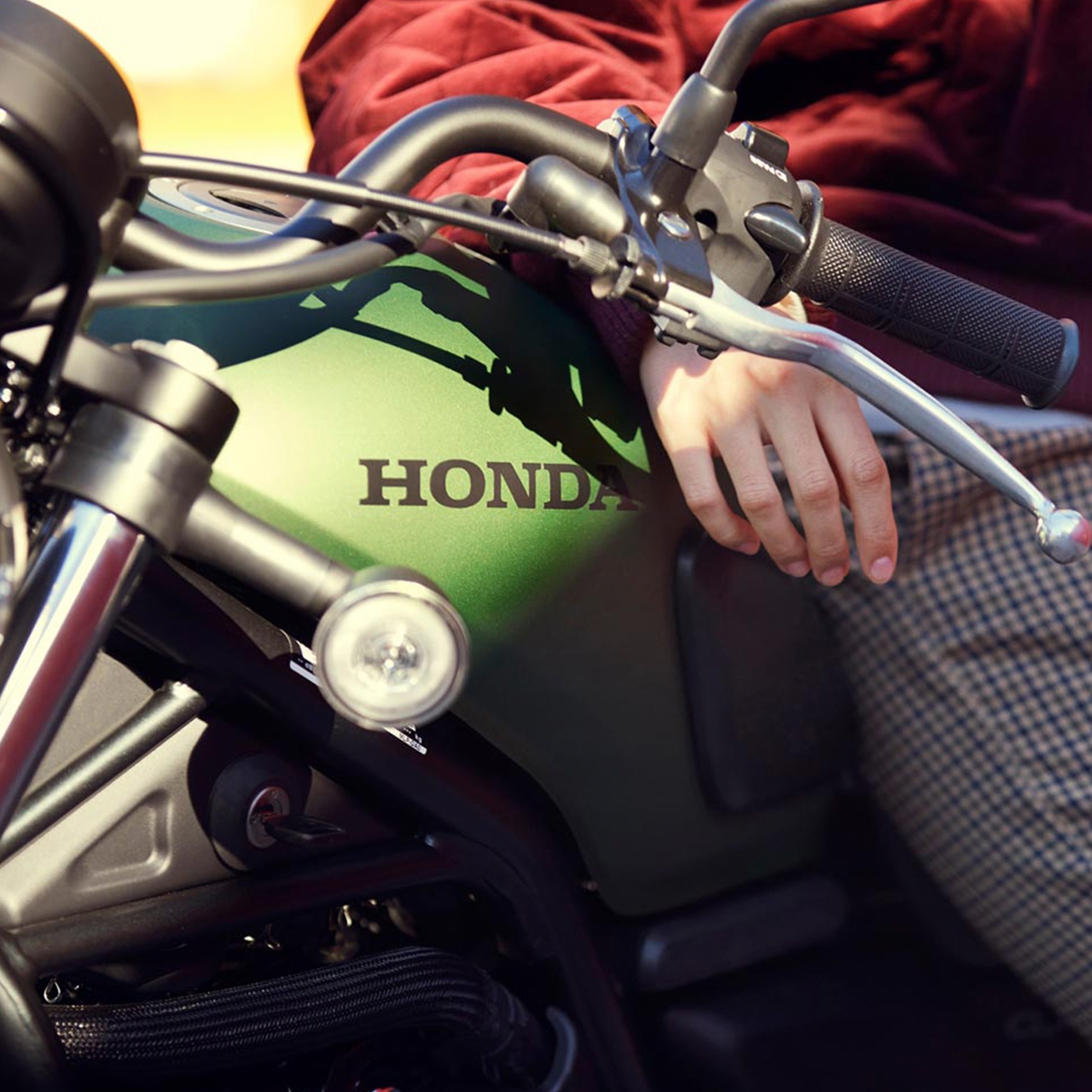 Close up side shot of the Honda CL500 motorcycle with model.