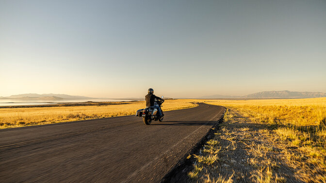 Model on a rear facing Honda CMX1100 Rebel in road location. 