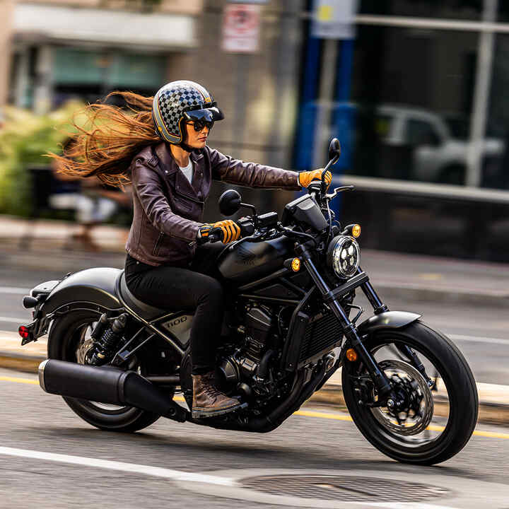 Model on Honda CMX1100 in city location.