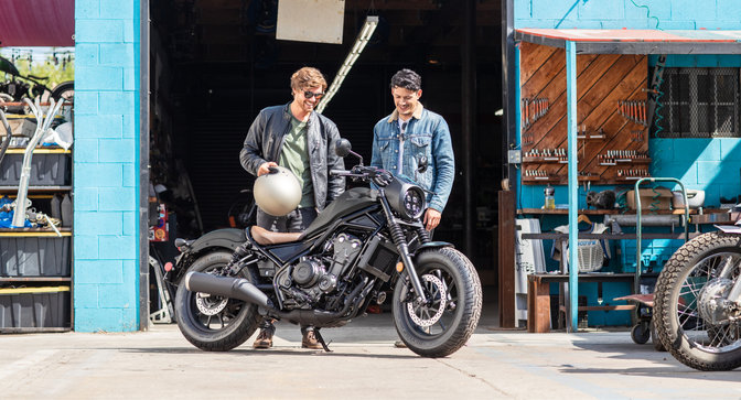 Honda CMX500 Rebel parked outside workshop.