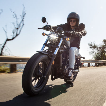 Side facing Honda CMX500 Rebel with rider.