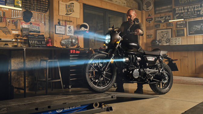 GB350S front ¾ shot with rider working on bike