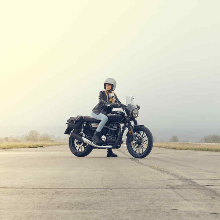 GB350S side on shot on runway with female rider