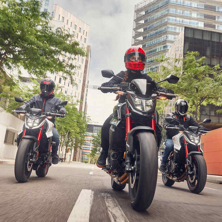 Three Honda CB750 Hornets on the road.