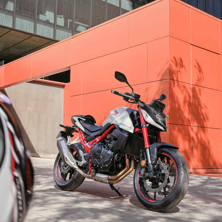 Honda CB750 Hornet in front of orange building.