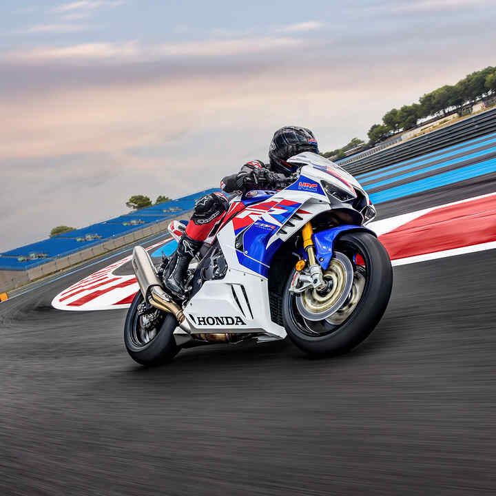 Right side front three quarter view of Honda CBR1000RR-R-Fireblade with a rider on a race track