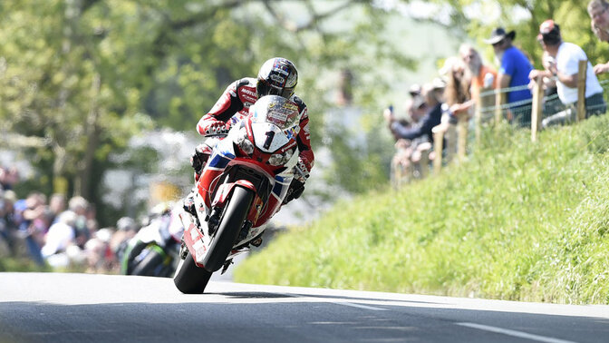 Honda 2012-2014 CBR1000RR with a rider on a race track. Photo credit: 2014 image - Isle of Man TT races