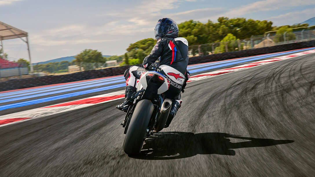 Rear side of Honda CBR1000RR-R Fireblade with a rider on a race track