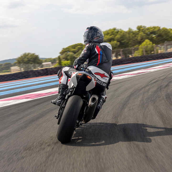 Rear side of Honda CBR1000RR-R Fireblade with a rider on a race track