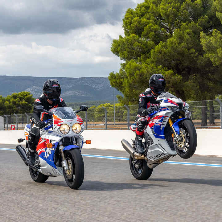 Three  side facing Honda CBR1000RR-R Fireblade and Fireblade SP parked on a racing track