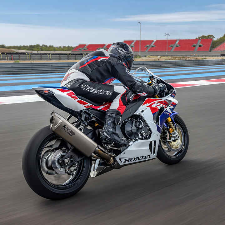 Rear facing three quarters of Honda CBR1000RR-R-Fireblade with a rider on a race track