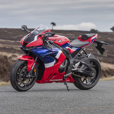 Honda CBR1000RR-R Fireblade 3 quarter front right side parked on countryside road red bike