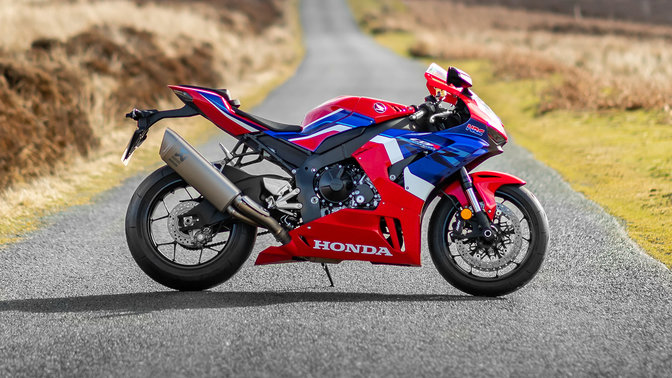 Honda CBR1000RR-R Fireblade left side parked on countryside road red bike