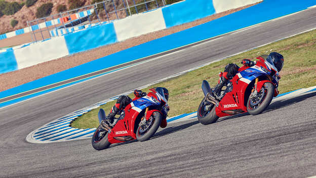 Riders on Honda CBR1000rr-r Fireblade on the track in corner.