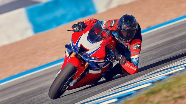 Rider on Honda CBR1000rr-r Fireblade on the track in corner.