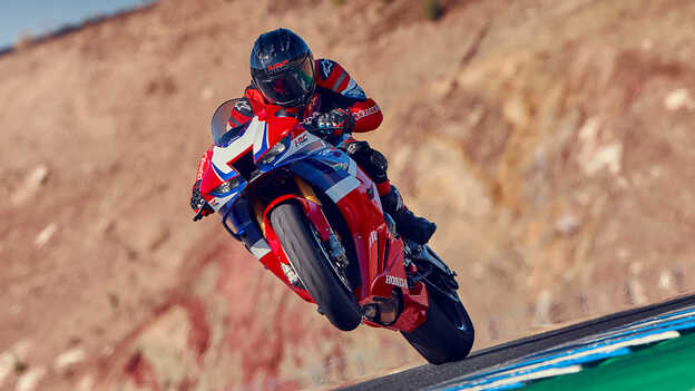 Rider on Honda CBR1000rr-r Fireblade on the track front wheel up.