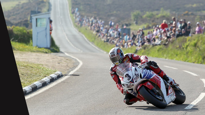 Front three quarter view of Honda CBR1000RR and rider in the TT race.