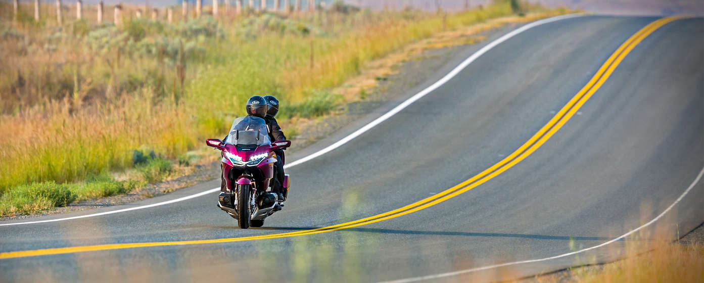 Rider and pillion passenger on a Honda Goldwing.