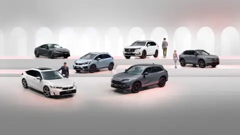 Honda electrified range including a grey Prelude, white CR-V, grey HR-V, light blue Jazz, grey ZR-V, and white Civic.