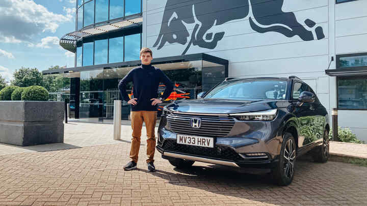 Max Verstappen standing next to a Honda HR-V