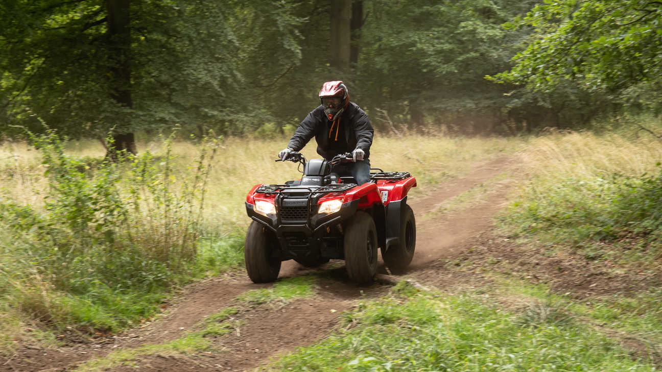 Fourtrax 420 being used in steep field location.