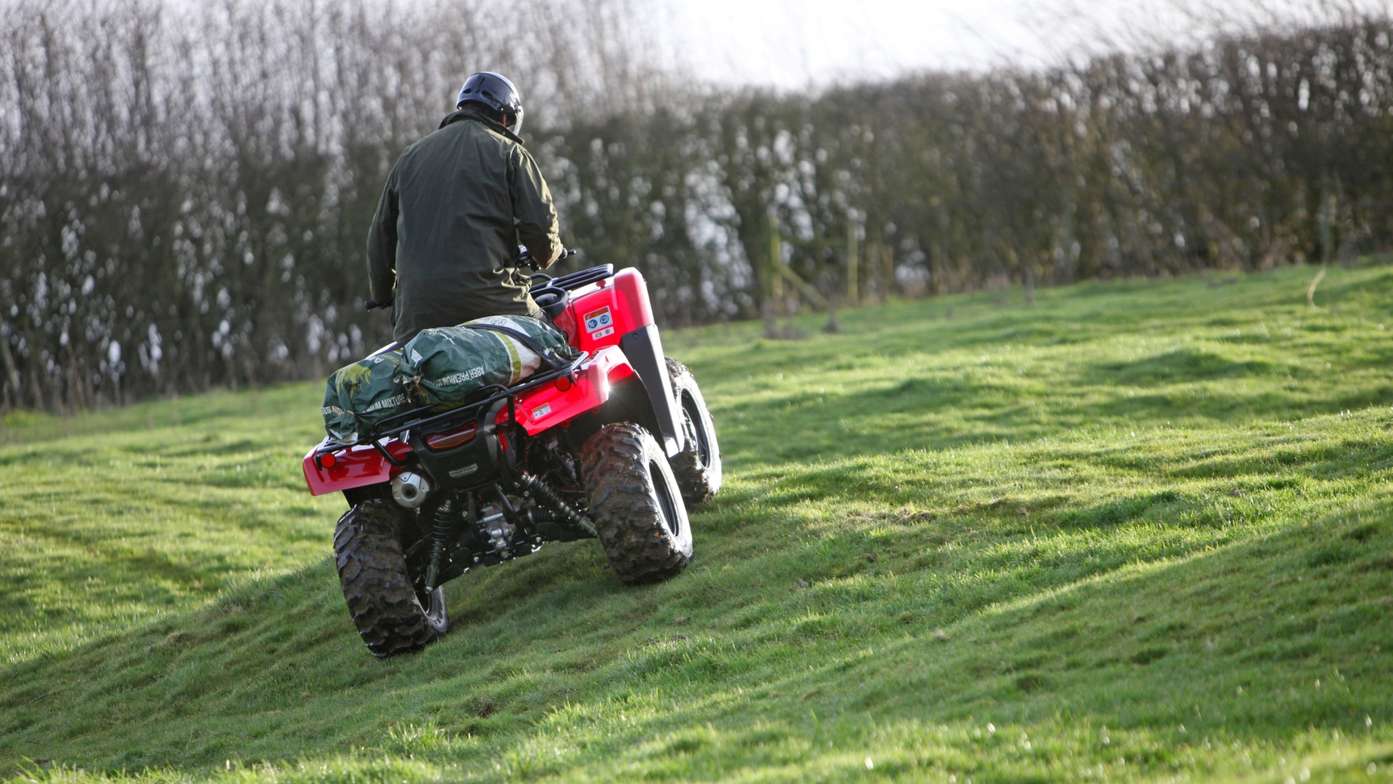 Fourtrax 420 being used in steep field location.