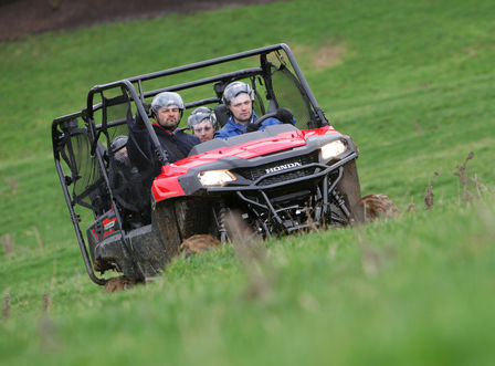Front three-quarter facing Honda Pioneer ATV in action.