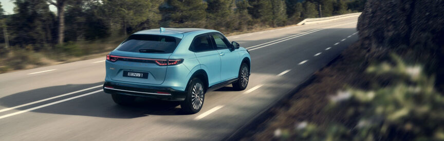 Honda e parked outside a building