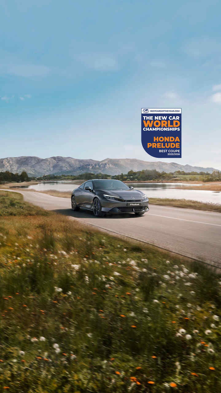 Honda prelude in a mountain setting with the award logo above it to the right