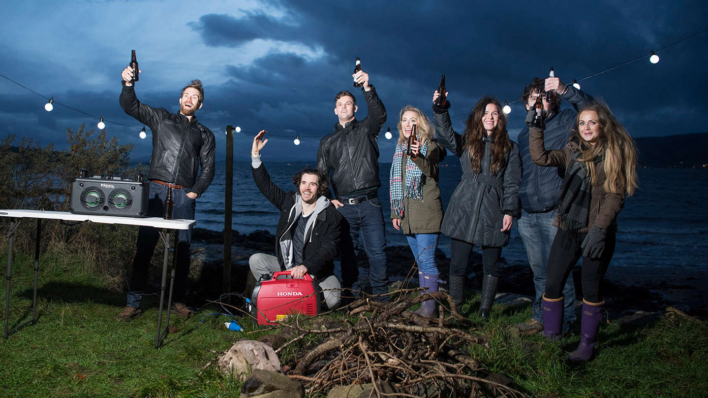 shot of a group of people by the lake using eu22i inverter power generator with gxr120 engine.